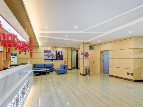 a lobby of a hospital with blue chairs and a waiting room at Chonpines Hotel·Jining Railway Station Wanda Plaza in Jining