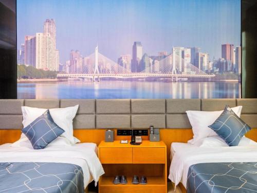 a hotel room with two beds and a large painting of a bridge at Chonpines Hotel Guangzhou Sunac Cultural and Tourism City Shiling in Huadu