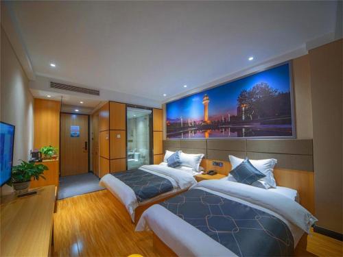 a bedroom with two beds and a large painting on the wall at Chonpines Hotel·Rizhao Yingbing Road RT-Mart in Rizhao