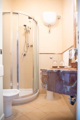 a bathroom with a shower and a sink and a toilet at Relais Villa Giuliana in Licata