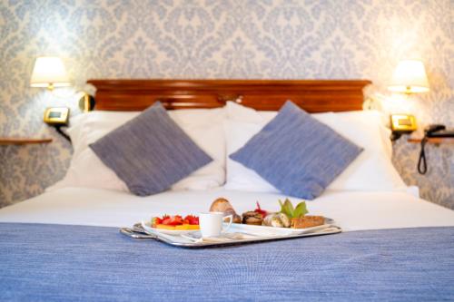 a tray of food sitting on top of a bed at Relais Villa Giuliana in Licata