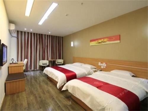 a hotel room with two beds and a television at Thank Inn Plus Hotel Zhuhai Nanping pedestrian Street Huafa shopping Center in Nanping