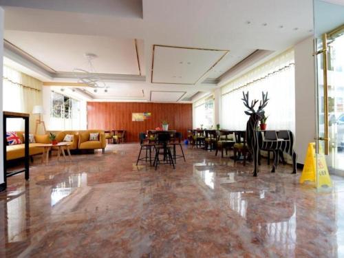 uma grande sala com mesas e cadeiras num edifício em Shell Linzhi Bayi Area G318 Shuangyong Road Hotel em Nyingchi