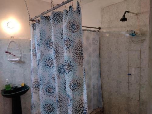 a bathroom with a shower with a shower curtain at Luz del Mar Paredón in Sipacate