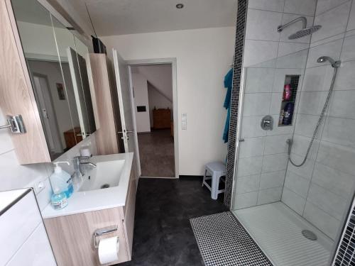 a bathroom with a sink and a shower at Ferienwohnung Wahler in Ramsthal