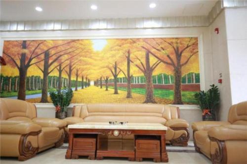 a living room with a large painting of trees at City Comfort Inn Shenzhen Longhua Guanlan Metro Station in Tiantangwei