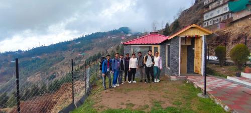 a group of people standing in front of a building at Anubhav Homestay Fagu in Theog