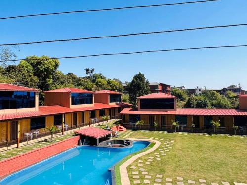 an image of a resort with a swimming pool at Arya's Village in Mahabaleshwar