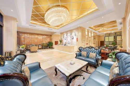 a living room with blue chairs and a table at Laog hao hotel in Shunde