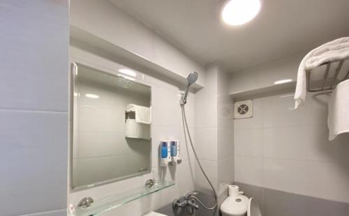 a bathroom with a shower and a sink and a mirror at Bích Ngọc Hotel Hà Nội in Hanoi