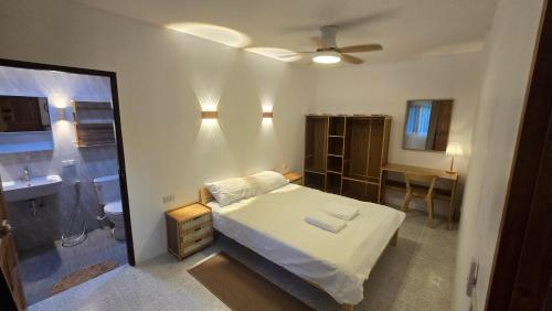 a small bedroom with a bed and a bathroom at Gecko House Koh Kood in Ban Bang Bao