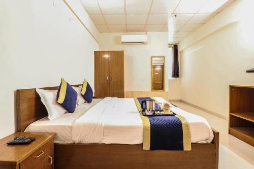 a bedroom with a large bed with a night stand at Hotel PARAS TOWER in Dehradun