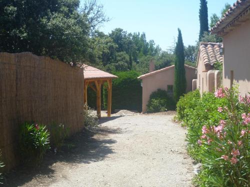 une allée menant à une maison avec une clôture dans l'établissement Les Tournillayres, à Bédoin