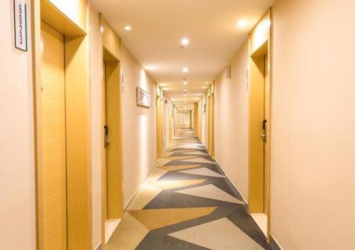 a corridor of a hallway with a long hallway at City Comfort Inn Changchun Jida First Hospital Xi Minzhu Street in Changchun