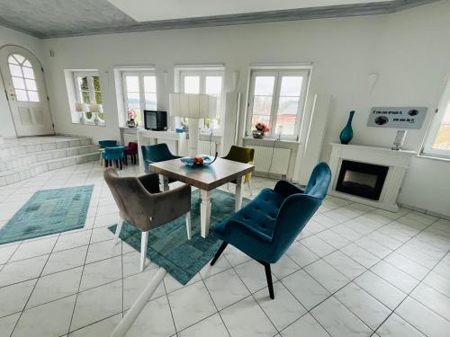 a living room with a table and chairs at Haus Rehlein in Pleiskirchen
