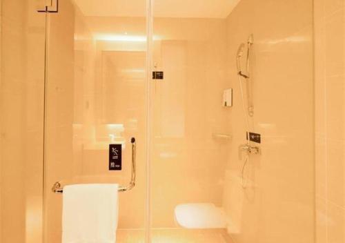 a bathroom with a shower and a toilet at City Comfort Inn Wuzhou Municipal Government Vocational College in Wuzhou