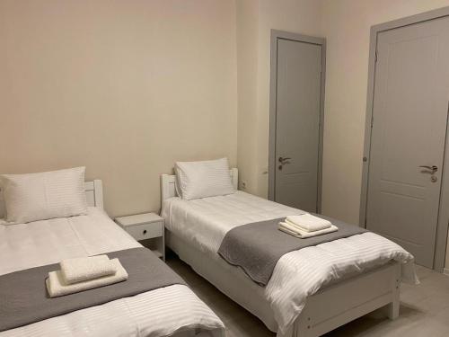 a bedroom with two beds with towels on them at Cultural Crossing Hotel in Tbilisi City