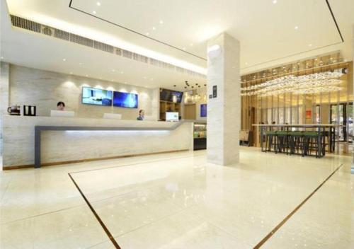 a large lobby with a bar in a building at City Comfort Inn Zunyi Meeting Site Medical College in Zunyi