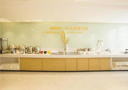 a kitchen with a sink and a counter top at City Comfort Inn Zhanjiang South Railway Station in Zhanjiang