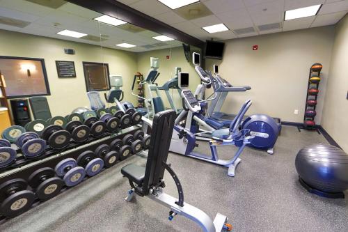 a gym with several exercise bikes and weights at Hilton Garden Inn Savannah Historic District in Savannah