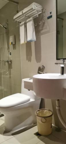 a bathroom with a toilet and a sink and a shower at City Comfort Inn Changsha Hunan Mass Media College in Xingsha