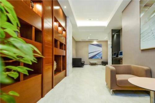 an office lobby with a chair and a table at City Comfort Inn Yibin Cuipingshan Park in Nanguang
