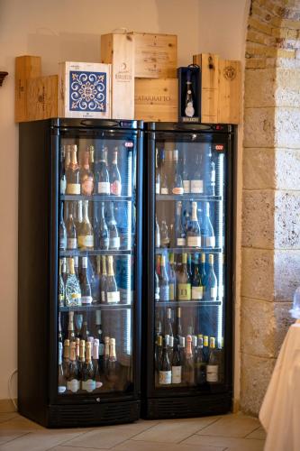 a refrigerator filled with lots of bottles of beer at Relais Villa Giuliana in Licata