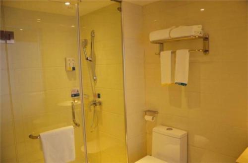a bathroom with a shower and a toilet at City Comfort Inn Yichang East Station Rose Garden Global Harbor in Baiyang