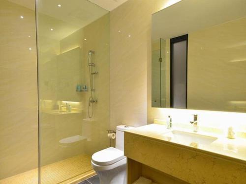 a bathroom with a toilet and a sink and a shower at City Comfort Inn Yichang Shenxiwan Three Gorges Highway Intersection in Yichang