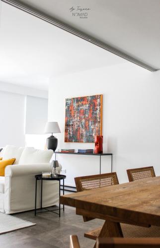 a living room with a white couch and a table at Nomad Houses - Ap Tereno in Beja