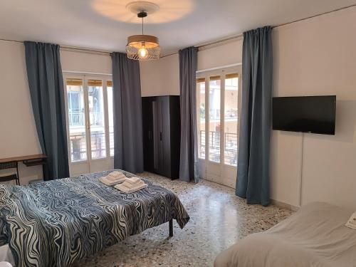 a bedroom with a bed and a flat screen tv at B&B Napoli Fuorigrotta in Naples
