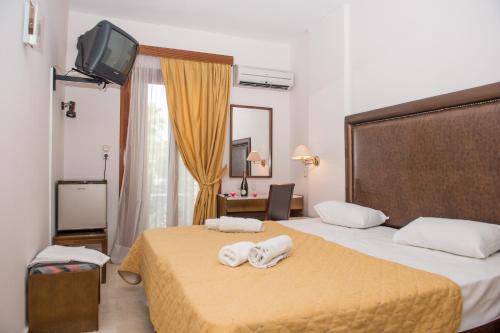 a hotel room with two beds with towels on them at Verdelis Inn in Ancient Epidavros