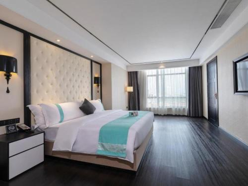 Krevet ili kreveti u jedinici u okviru objekta Xana Hotelle· Dongguang Chang'An Binhaiwan Jian'An Road