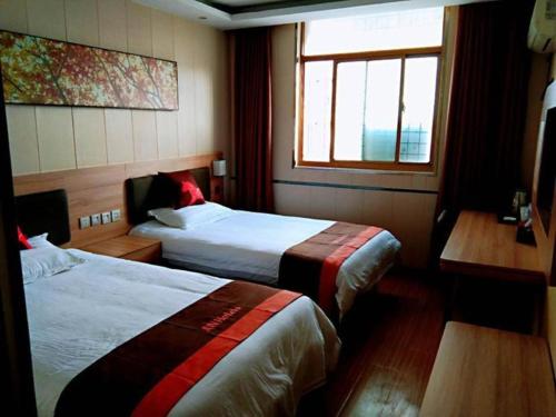 Ένα ή περισσότερα κρεβάτια σε δωμάτιο στο Jun Hotel Anhui Bozhou Lixin County Wenzhou Road