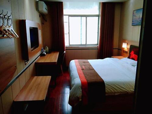 Jun Hotel Anhui Bozhou Lixin County Wenzhou Road tesisinde bir odada yatak veya yataklar