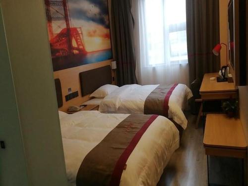 a hotel room with two beds and a desk at Thank Inn Hotel Sichuan Nanchong Gaoping District Longmen 