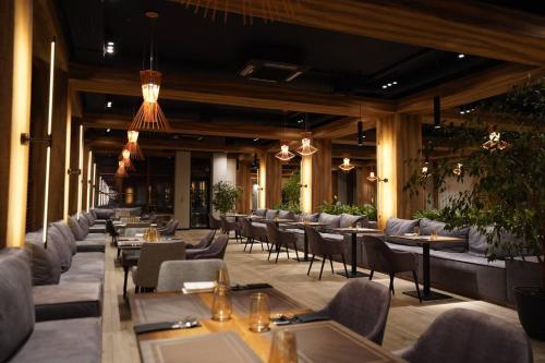 a restaurant with tables and chairs in a building at Wood Hotel Resort & SPA in Bukovel