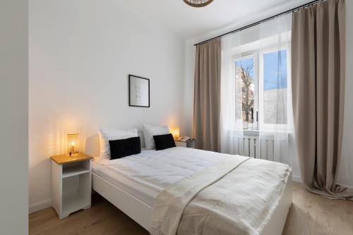Ένα ή περισσότερα κρεβάτια σε δωμάτιο στο Elite Apartments Podbielańska Center