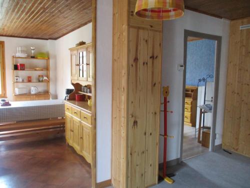 a kitchen with a wooden door in a room at Gîte au chemin des Cordonniers in Gresse-en-Vercors