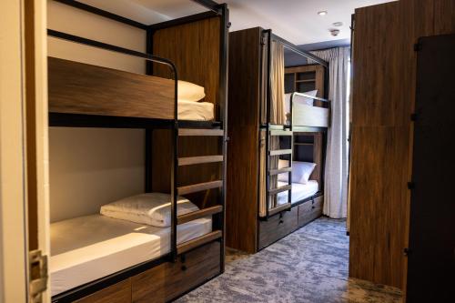 a group of bunk beds in a room at Haka House Queenstown Lakefront in Queenstown