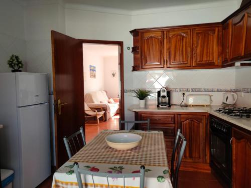 a kitchen with a table with a bowl on it at Lodge & Hike Almograve in Almograve