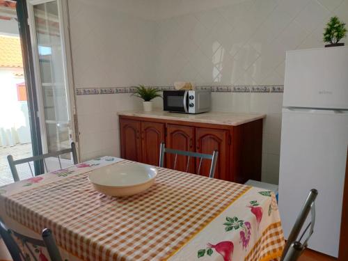 a kitchen with a table with a bowl on it at Lodge & Hike Almograve in Almograve