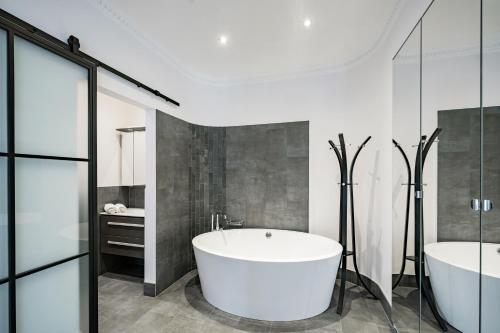 a bathroom with two sinks and a bath tub at Celine Residence Luxury in Budapest