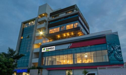 a tall building with a sign in front of it at Treebo The Square in Ahmedabad