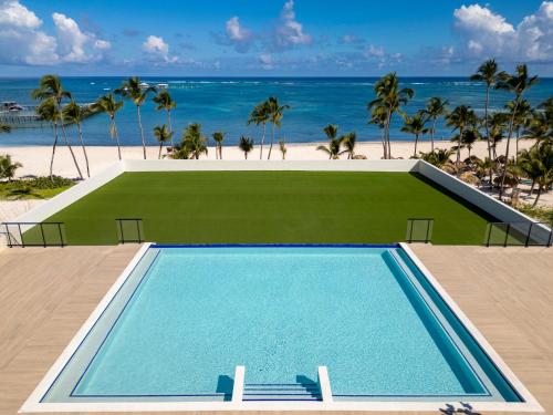 a swimming pool with the beach in the background at Serenade All Suites - Adults Only Resort in Punta Cana