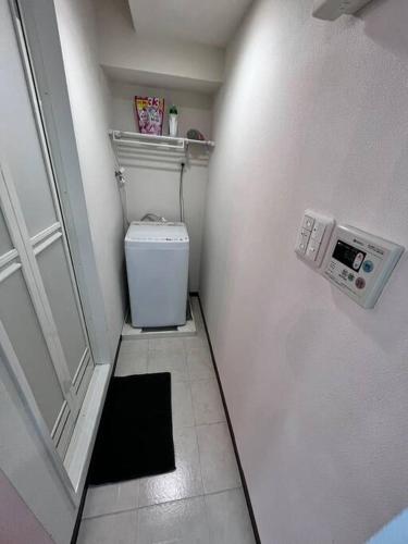a small bathroom with a toilet and a door at 下寺3楼 in Osaka