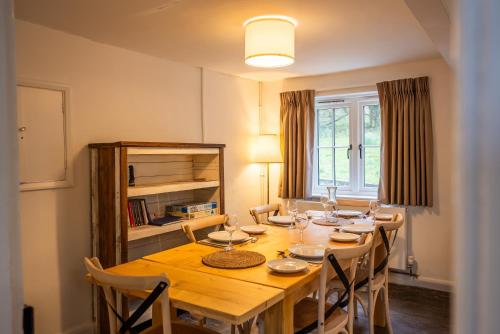 a dining room with a wooden table and chairs at Skylark Cottage at Seven Sisters in West Dean