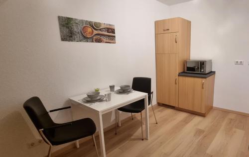 een kleine witte tafel en stoelen in een kamer bij Ferienwohnung Parkblick in Bad Berleburg