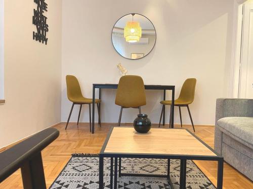 a living room with a table and chairs at City Break Apartments Klishe Zen in Belgrade