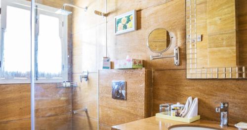 a bathroom with a shower and a sink at Karma Chalets in Gurgaon